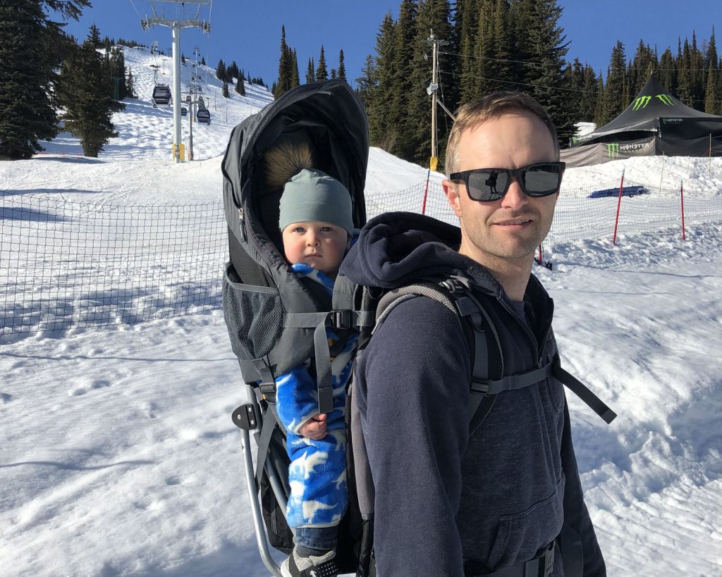 Will Devick of dlandco chartered professional accountants backpacking son Hudson during a ski trip in Revelstoke BC